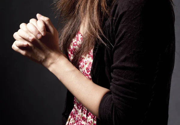 Close up of hands in praying. Young woman is in praying. Religious Praying Woman