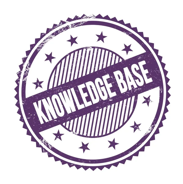 KNOWLEDGE BASE text written on purple indigo grungy zig zag borders round stamp.