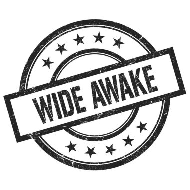 WIDE AWAKE siyah yuvarlak vintage kauçuk damga üzerine yazılmış metin.