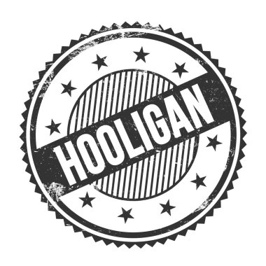 Siyah grungy zig zag kenarları üzerine yazılmış HOOLIGAN metni yuvarlak pul.