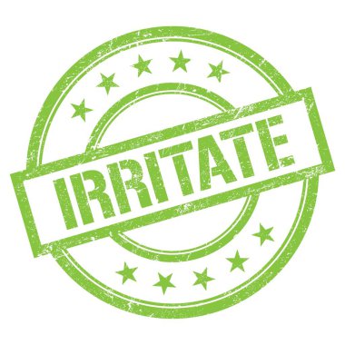 Yeşil yuvarlak vintage kauçuk damgalı IRRITATE metni.