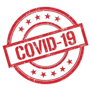 Kırmızı yuvarlak plastik damga üzerine yazılmış COVID-19 metni.