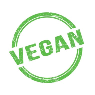 Yeşil grungy vintage yuvarlak pulu üzerine yazılmış VEGAN metni.