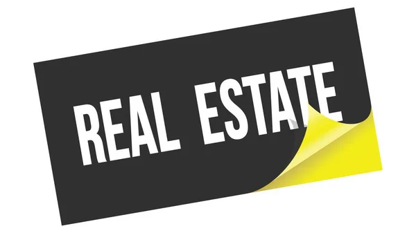 Real Estate Tekst Napisany Czarno Żółtej Naklejce — Zdjęcie stockowe