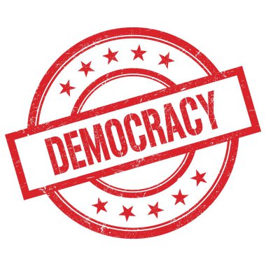 Kırmızı, yuvarlak, lastik damgalı DEMOCRACY metni.