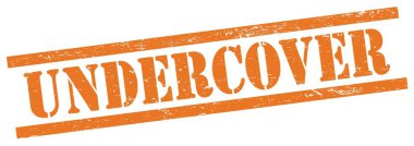UNDERCOVER 'un turuncu grungy dikdörtgen vintage pulu üzerindeki metni.