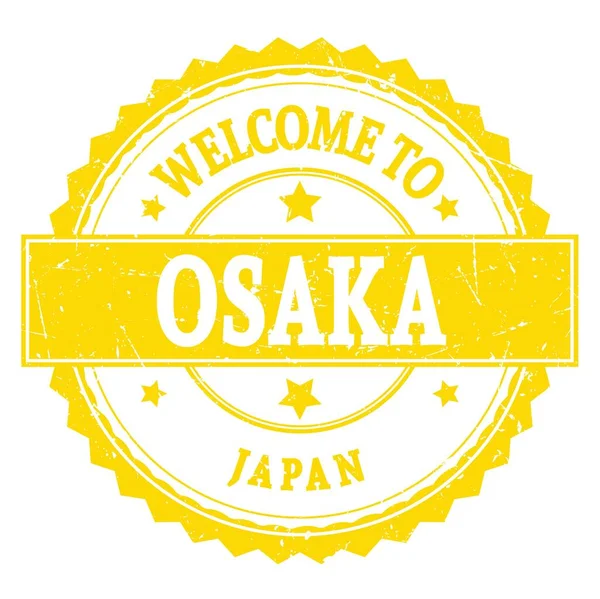 欢迎来到Osaka 写在黄色圆形锯齿形邮票上的文字 — 图库照片
