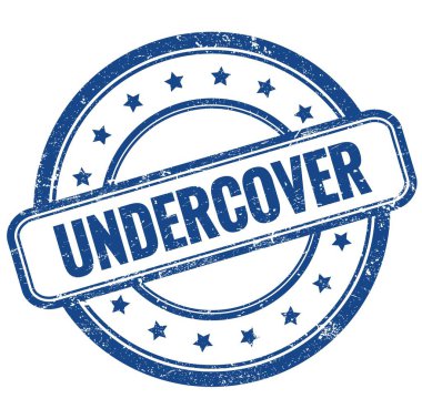 UNDERCOVER 'un mavi antika, pasaklı, yuvarlak lastik damgalı metni.