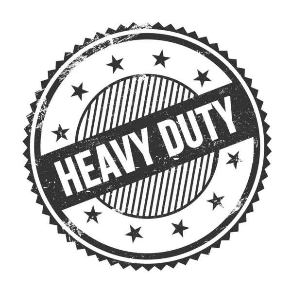 Siyah grungy zig zag kenarlarında yazılmış HeaVY görev metni yuvarlak pul.