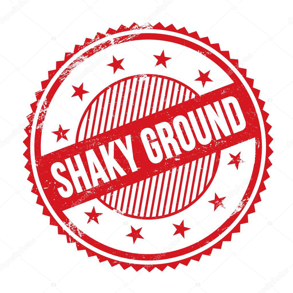 SHAKY GROUND text written on red grungy zig zag borders round stamp.