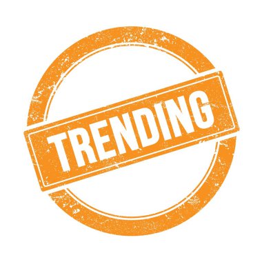 Turuncu grungy yuvarlak vintage damga üzerinde TRENDING metin.