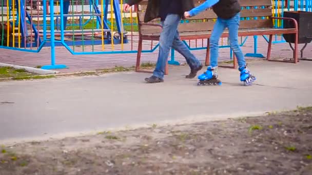 The child learns to ride on roller skates — Stock Video