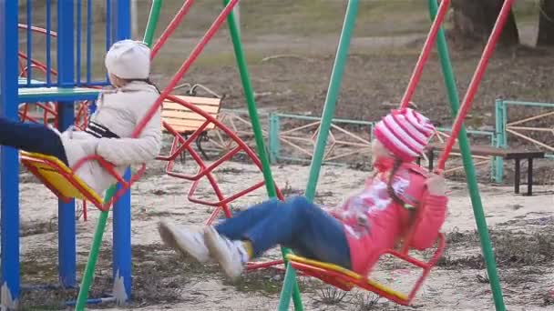 Kinderen rijden op een schommel — Stockvideo