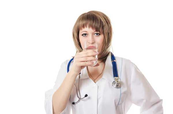 The doctor drinks water from a glass Stock Image