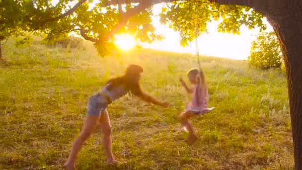 Mother swings the daughter on a swing — Stock Video