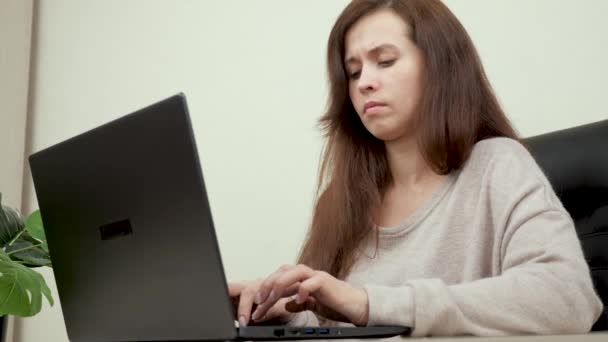 Жінка в офісі працює на сучасному комп'ютері. Ділова жінка друкує текст на клавіатурі ноутбука. Жіночі руки бізнес-леді, що працюють на комп'ютері. Жінка сидить за домашнім офісом, працює онлайн — стокове відео
