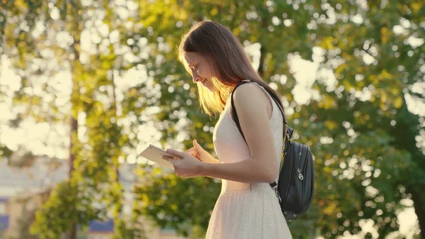 Students hands touch touch screen of tablet. Freelancer woman working with tablet computer walking on sidewalk in city. Business woman using digital tablet prints messages on city street.