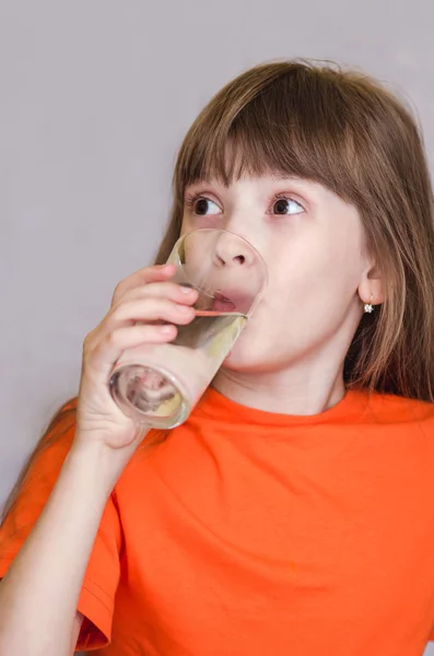 Girl drinking water and smiling — Stock Photo, Image