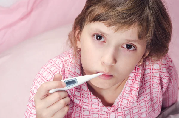The girl holds a thermometer in a mouth — Stock Photo, Image