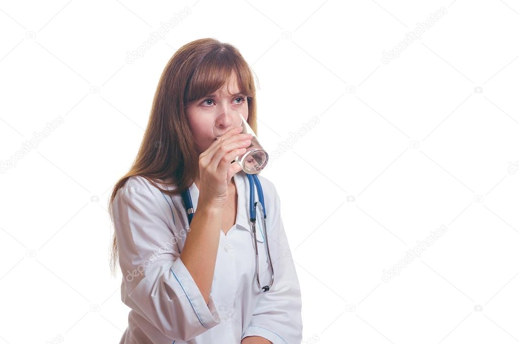 The doctor drinks water from a glass