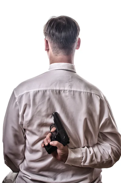 O homem segura a arma atrás das costas — Fotografia de Stock