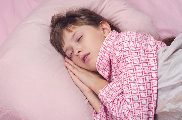 The little girl sleeps in a bed — Stock Photo, Image