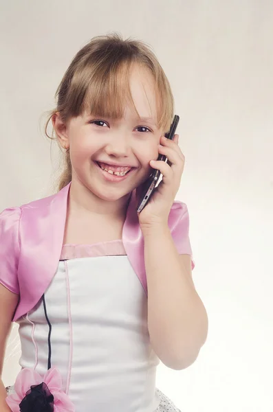 The girl speaks by phone and smiles — Φωτογραφία Αρχείου