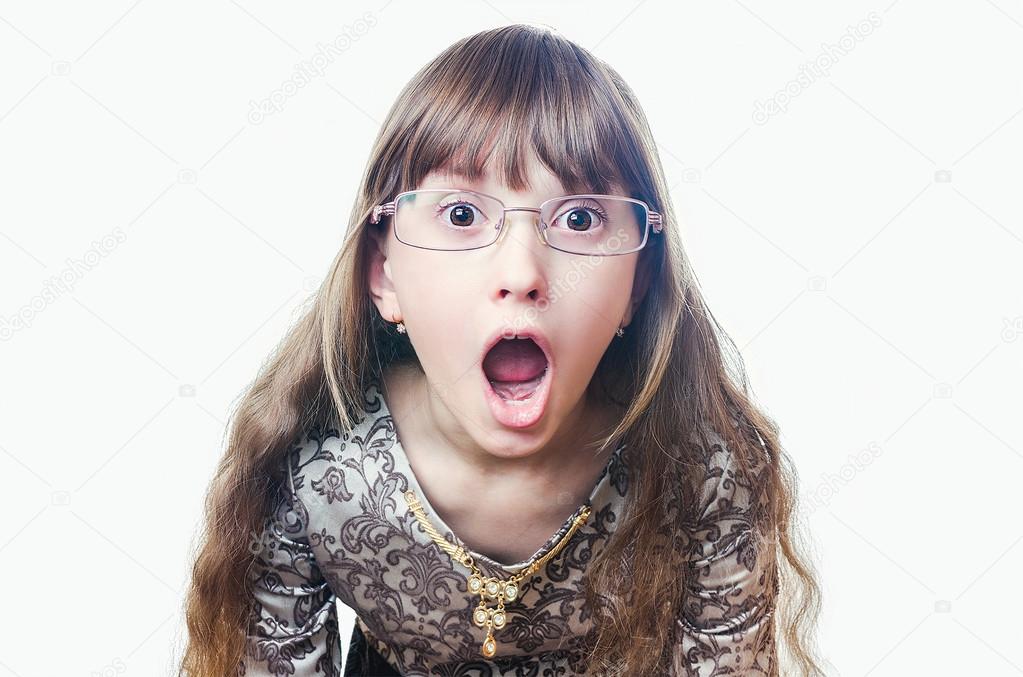 The girl wearing spectacles and a dress opened a mouth from surp