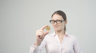 Elinde bitcoin kripto para tutan bir kadın.