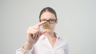 golden bitcoin in the hand of a beautiful business girl clipart