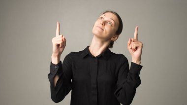 Genç kadın bir şey gösteriyor.