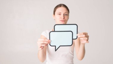 Elinde konuşma balonu tutan genç bir kadın. 