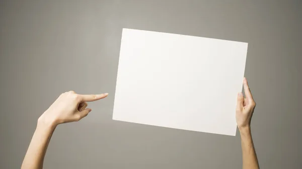 Person holding white empty paper