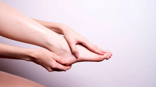 massage of leg muscles with hands, leg pain