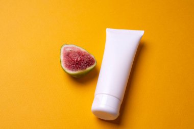 Sarı arka planda el ya da yüz kremi paketleme