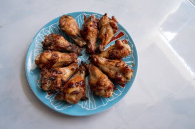 Kızarmış tavuk butları bir tabakta.