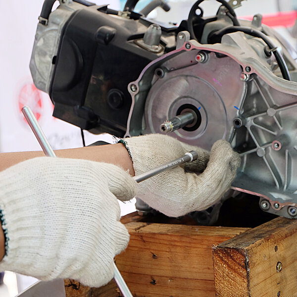 Hands of disassembly kit motorcycle in repair service. Automotive engine disassembly kit motorcycle.