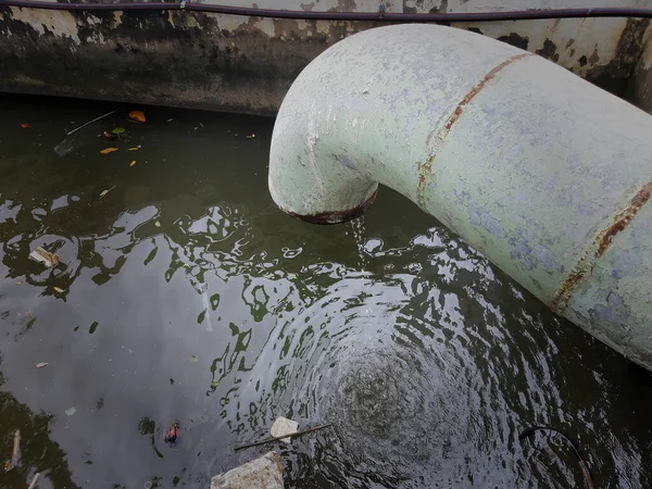 Waste pipe or drainage polluting the environment. The wastewater pipe from the village into the canal.