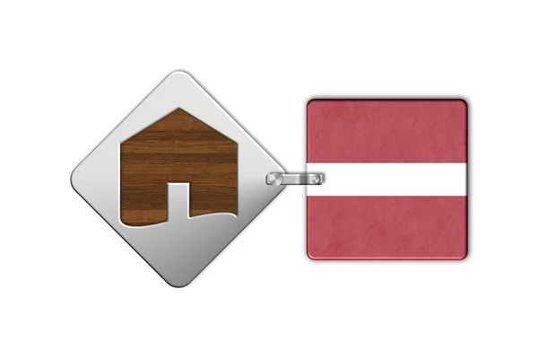 Symbolem domu w stali i drewna z flaga Łotwy — Zdjęcie stockowe