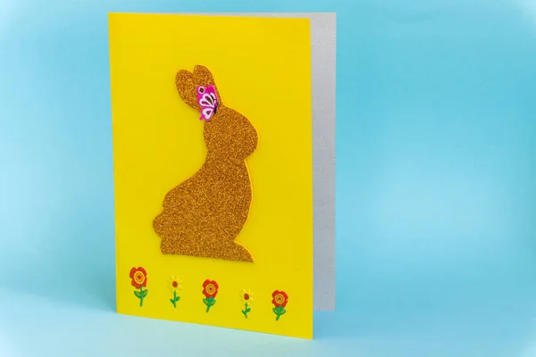 Diy Easter cards from paper. Volume greeting cards with a bunny, on blue background. 3d. Gift idea, decor Spring, Easter. Step by step. Top view. Process kid children craft. Colorful holiday decoration