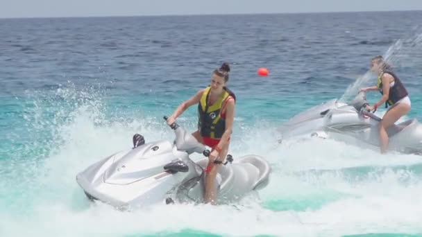 Girlfriends riding on jet skis in the sea — Stock Video