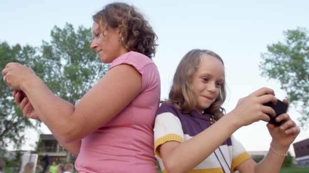 Mother And Daughter using Mobile Phones — Stock Video