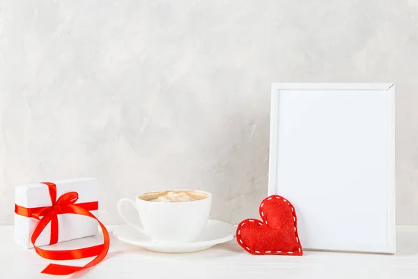 A gift, red heart, morning coffee against the background of light wall, concept, a postcard for Valentine\'s Day. Copy space.