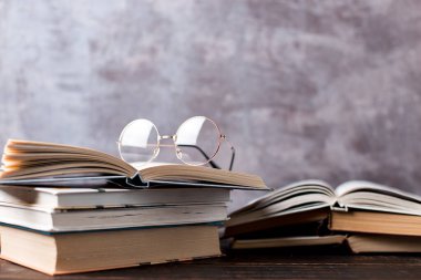 Concept to teacher's day. Pens, apple, pencils, books and glasses on table. Back to school, copy space.