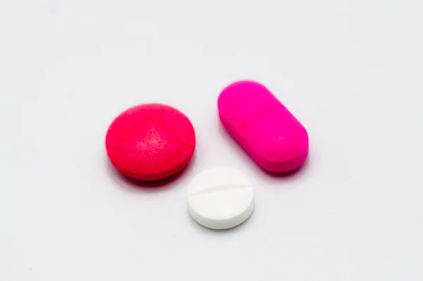 Comprimidos brancos e vermelhos e rosa Fotografia De Stock