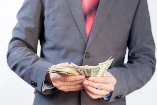 Empresario contando billetes en blanco aislado — Foto de Stock
