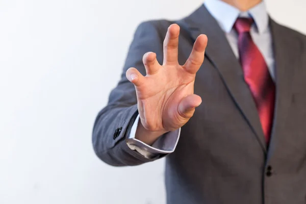 Бизнесмен щипает в воздухе пятью пальцами — стоковое фото