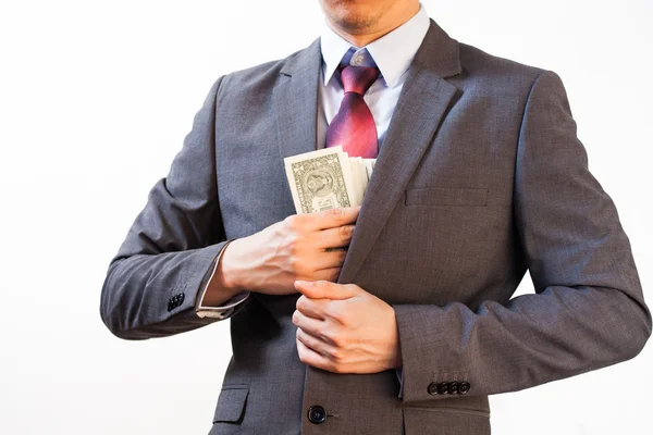 Hombre de negocios escondiendo dinero en el bolsillo de la chaqueta — Foto de Stock