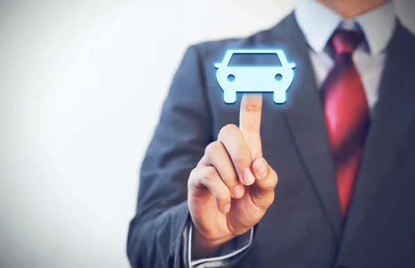 Empresário pressionando ícone do carro no ar com um dedo — Fotografia de Stock