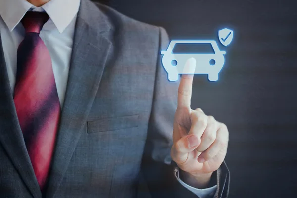 Biznesmen naciśnięcie ubezpieczony samochód ikona w powietrzu z jednym palcem — Zdjęcie stockowe